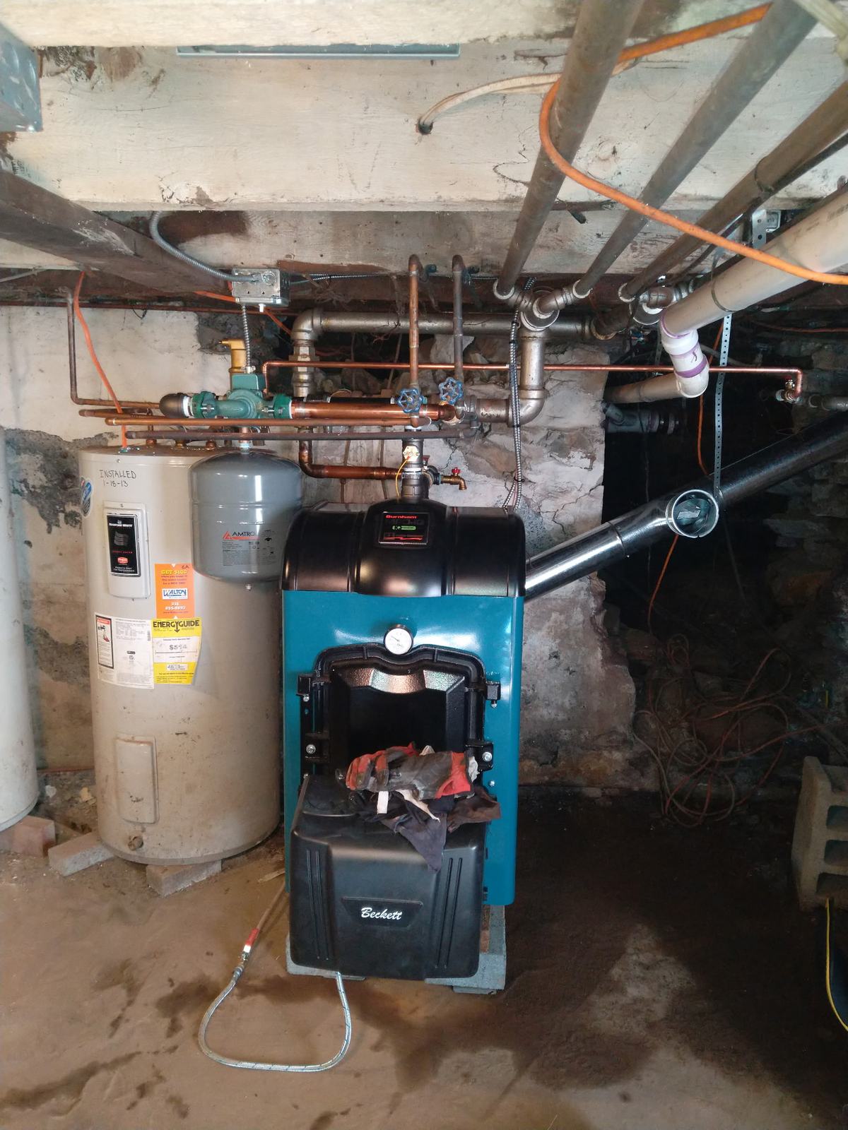 Oil boiler and water heater replacement in an old stone foundation basement