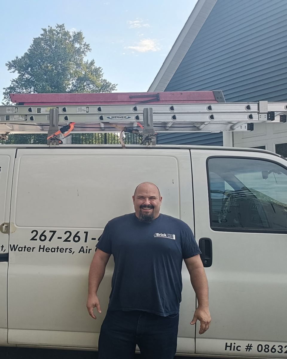 Jason, owner of JBrick Heating and Cooling, in front of the company van in Sellersville PA