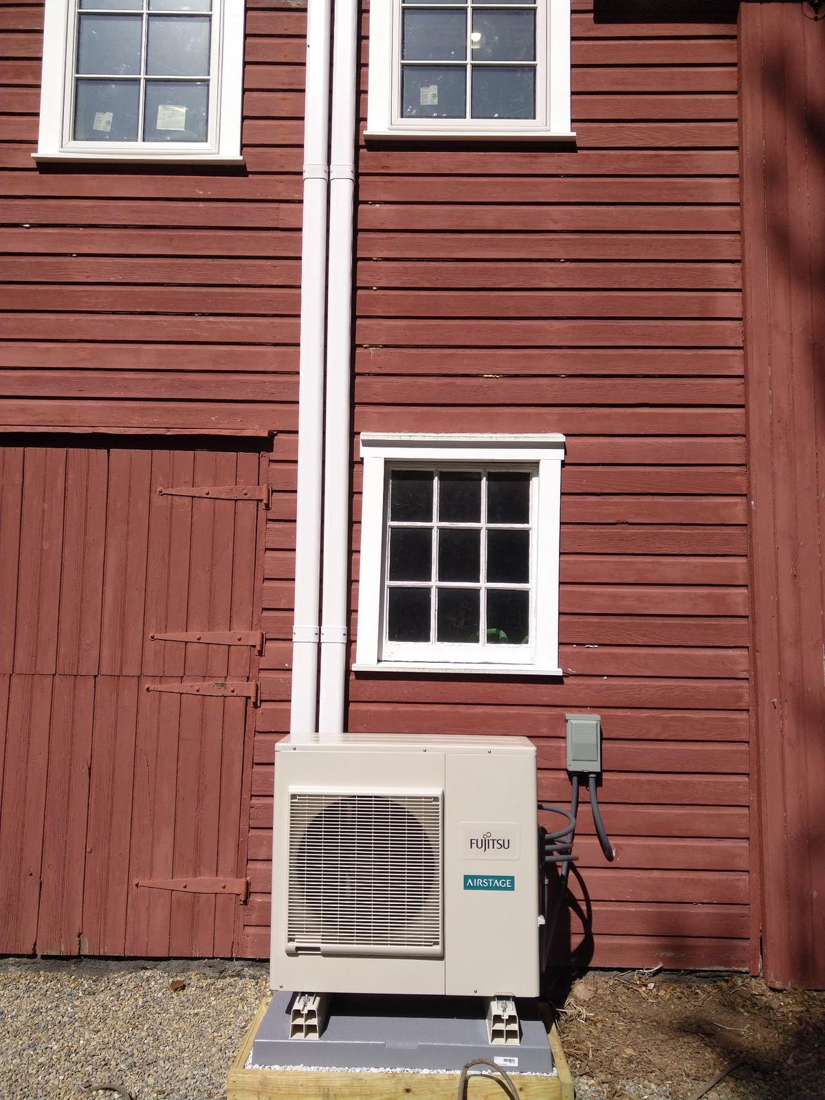 Ductless mini-split installed on a historic red barn