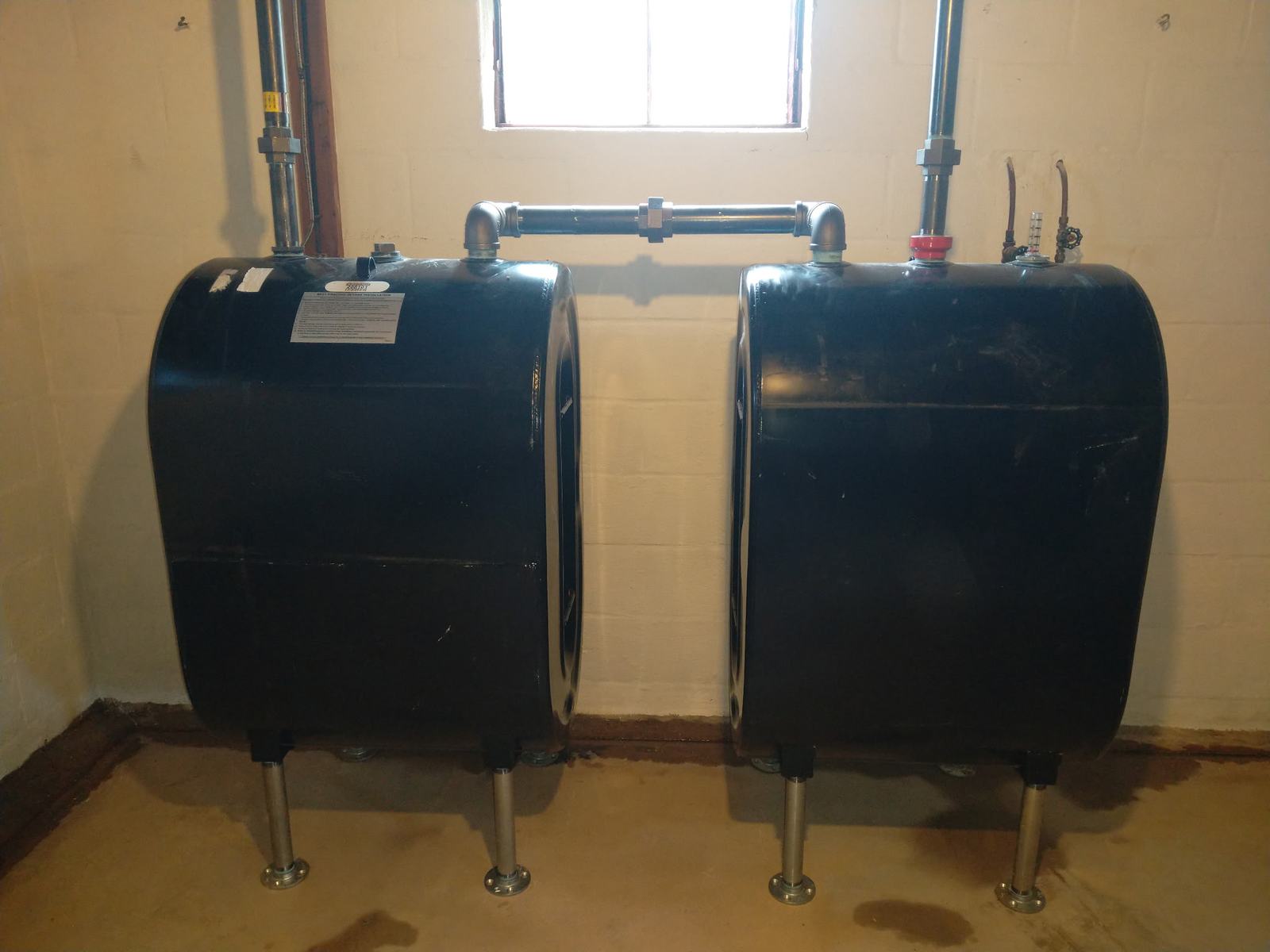 Twin oil storage tanks installed and manifolded together